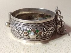 A superb old Berber silver bracelet from Morocco. The surface of the bangle has been finely hand-etched with a design combining lines with enamel, and the surface as well as interior have both obtained a very rich patina from wear and usage. It opens and closes with a pin. Inner diameter : 5,6 cm (2,2 inches) Width : 2,8 cm (1,1 inches) Weight : 73,6 g Silver Openable Bracelets As A Gift, Silver Openable Bracelets For Gift, Silver Openable Bracelet For Gift, Traditional Engraved Bracelets, Ornate Engraved Bracelets For Festivals, Traditional Engraved Collectible Bangle, Antique Silver Bangle As Gift, Antique Engraved Bracelets For Festivals, Traditional Silver Stamped Bracelets