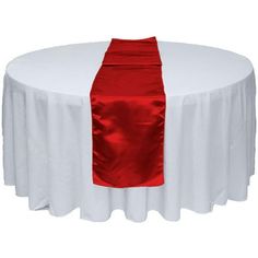 a white table topped with a red chair cover