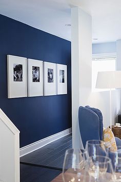 a room with blue walls and pictures on the wall