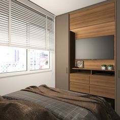 a bed sitting under a window next to a tv on top of a wooden dresser