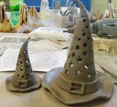 two clay witches hats sitting on top of a table