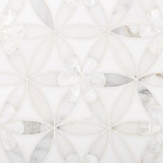 an intricate white tile design on the wall