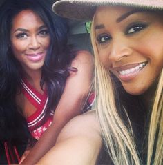 two beautiful young women sitting next to each other in a car with one smiling at the camera