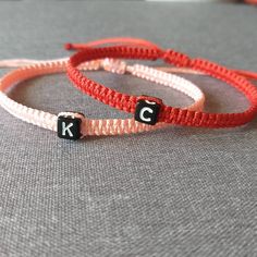 "Add to cart and write in the note to seller initials you need. You will receive: -Two adjustable knotted bracelets in the colors of your choice, -Organza bag, ready for gift giving! Materials: - Highest quality nylon cord and . Choose the bracelet color from the drop-down menu. Size: - Woman size adjustable approx. from 7\" up to 11\". - Man size adjustable approx. from 7,5\" up to 12\". - My sizes will fit most people, but if you are unsure and require bracelets for particularly large or small Adjustable Letter-shaped Friendship Bracelets, Friendship Bracelets With Letter Beads For Valentine's Day, Adjustable Initials Name Bracelet As Gift, Adjustable Initials Name Bracelet For Gift, Adjustable Initials Name Bracelet For Mother's Day, Personalized Red Letter Beads Bracelet, Adjustable Initials Bracelet For Friendship, Personalized Red Bracelet For Birthday Gift, Initials Bracelet