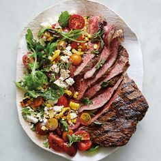 steak with corn, tomato and feta salad on a plate