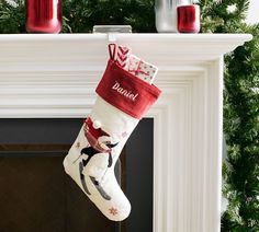 a christmas stocking hanging from a fireplace mantel