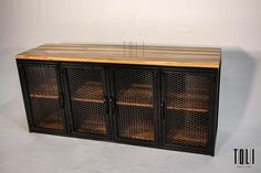 a wooden cabinet with metal mesh doors