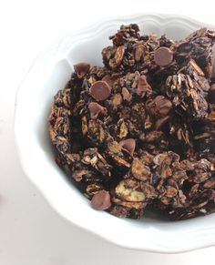 a white bowl filled with cookies and chocolate chips