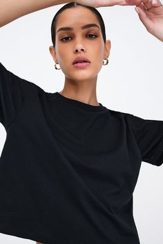 Our Rya Tee is for those who expect their basics to go above and beyond. Fashioned from French organic cotton jersey, she offers unrivaled softness and breathability in a cropped, oversized cut. With short sleeves and a rib-knit crew neck for visual interest, this classic tee works solo or as a base to create countless unique looks.[SPLIT] Astrid, in black, is 5'9" (175 cm) tall, wearing size XS. Rocio, in white, is 5'9.5" (175 cm) tall, wearing size XS. Total length is approximately 20" (51 cm) Oversized Trendy Cropped T-shirt With Short Sleeves, Boxy Short Sleeve Basic Cropped T-shirt, Relaxed Fit Cropped T-shirt For Everyday, Oversized Short Sleeve T-shirt With Ribbed Neckline, Basic Cropped T-shirt For Loungewear, Solid Boxy Fit Cropped T-shirt With Crew Neck, Basic Relaxed Fit Cropped Shirt For Streetwear, Basic Boxy Fit Crop Top With Crew Neck, Trendy Oversized Cropped T-shirt For Loungewear