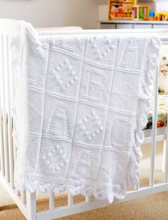 a crib with a white blanket on top of it in a child's room