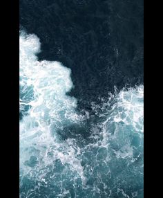 an aerial view of the ocean with waves