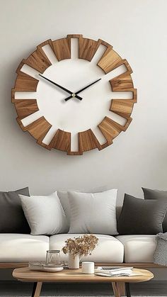 a living room filled with furniture and a large clock mounted to the wall above it