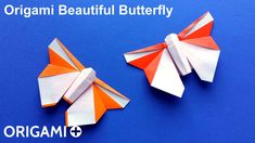 two orange and white origami bows on a blue background with one folded in half