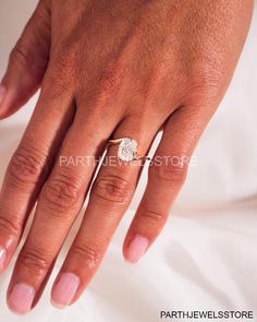 a woman's hand with a diamond ring on it