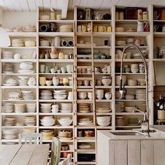 a kitchen filled with lots of white dishes