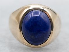 Show off your personality with this beautiful yellow gold bezel set oval cut lapis solitaire ring! The perfect combination of sparkle and sophistication, you'll love the unique shape and deep blue color of this statement piece! Wear it day or night for some extra wow-factor! Metal: 10K Yellow Gold Gem: Lapis 2.59 Carats Gem Measurements: 8.5 x 10.2 mm, Oval Ring Size: 4.25 Marks: "10K" Stamped on the inside band SKU #: A35957 Each piece has been identified and graded by a Graduate Gemologist who Oval Lapis Lazuli Ring For Anniversary, Modern Blue Oval Signet Ring, Oval Lapis Lazuli Rings For Formal Occasions, Formal Lapis Lazuli Oval Rings, Luxury Lapis Lazuli Oval Rings, Luxury Oval Lapis Lazuli Rings, Oval Blue Lapis Lazuli Rings, Gold Lapis Lazuli Cabochon Jewelry, Vintage Lapis Lazuli Oval Jewelry