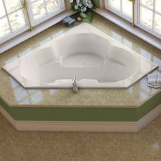 a large white bath tub sitting in the middle of a room next to two windows