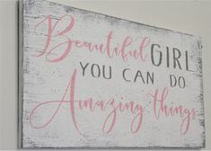 a wooden sign that says, beautiful girl you can do amazing things with pink ink