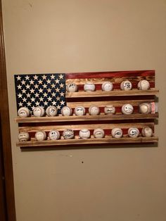 an american flag made out of baseballs hanging on a wall