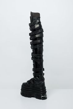 Vetements and New Rock collaborated for Fall/Winter 2024 with the thigh-high gamer boot. These black leather boots feature metal rivets, studs, and hardware accents throughout, including on the toe, heel, and sole. The design incorporates an extended padded tongue, velcro straps, and side cutouts. Cargo Coat, Candle Reading, Laquan Smith, Charlotte Chesnais, Craig Green, Scarf Shirt, Shirts For Leggings, New Rock, Fall Winter 2024