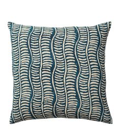 a blue and white pillow with wavy lines on it