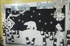 a bulletin board with penguins and polar bears on it, surrounded by snowflakes