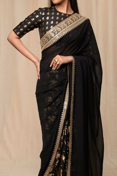 Editor's Note This black oasis saree comes with sheer palla is embellished with embroidered border and tassel detail to dazzle at a special occasion! It comes with black wallflower blouse piece Note: this sari is free size and comes with unstitched piece blouse (1 metre raw silk) Fabric: Raw Silk, organza Color: Black Fit: Free size Components: Sari and unstitched blouse piece Occasion: Festive and wedding guest Care: strictly dry clean only for digitally printed garments & non-petroleum dry cle Black Organza Saree, Caribbean Fashion, Wedding Lookbook, Indian Bridal Sarees, Raw Silk Fabric, Border Saree, Saree For Women, Print Saree, Saree Designs Party Wear