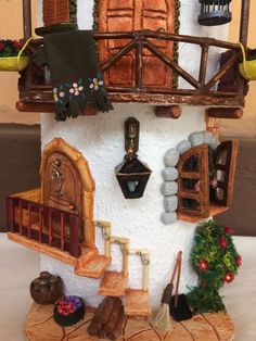 a doll house with lots of furniture and decorations on the outside, including a balcony