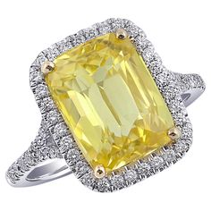 a fancy yellow diamond ring set in 18k white gold