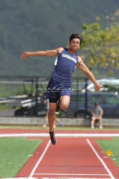 a man is jumping in the air on a track