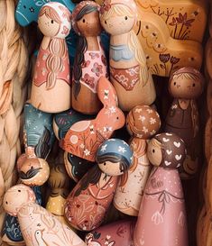 several wooden figurines are stacked in a basket