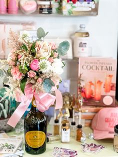 a bouquet of flowers is in a bottle on a table with other bottles and decorations