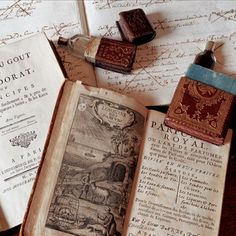 an open book sitting on top of a wooden table next to two rubber stampers