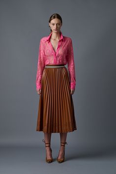 Our iconic pleated skirt updated for the fall season. Featuring a custom elastic waistband, this chic and stunning skirt offers effortless style. Enjoy the ease of pull on styling and the versatility to dress it up or down. 100% Polyurethane Cut-out details on hem Stretch waistband Model Measurements - Height: 5'10", Bust 32”, Waist 24 1/2", Hip 34 1/2" Model is wearing a size small Romper Pants, Knit Jacket, Fall Season, Skirt Pants, Signature Style, Model Measurements, To Meet, The Fall, Pleated Skirt