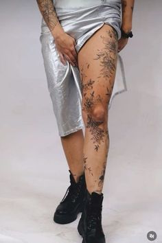 a woman with tattoos on her legs and leggings