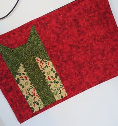 a close up of a piece of fabric on a white surface with a red background