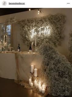 the table is decorated with candles and greenery