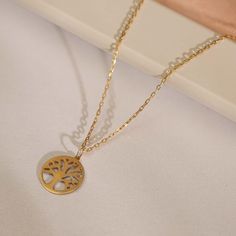 We channel our inner mother nature here with our diamond tree of life necklace. Give the natural woman the real diamond touch she needs. FEATURES * Made to order. * Gold KT: 14K * Gold Color Selection: Yellow Gold, Rose Gold, White Gold Diamond carat: 0.01 ct. Cut: Perfect cut Diamond type: Zircon Diamond Setting Type: Frame Setting * Pendant Height: 12 mm / 0.47 inch * Pendant Width: 12 mm / 0.47 inch * Length: 14", 16", 18", 20" * Ready to Ship in 1-3 Business Days * 100% sourced from the USA Elegant Yellow Gold Tree Of Life Necklace, Mother's Day Round Jewelry With Tree Of Life, White Gold Tree Of Life Jewelry As Gift, Tree Of Life Round Pendant Necklace For Mother's Day, Mother's Day Tree Of Life Round Necklace, Mother's Day Tree Of Life Necklace, Elegant Tree Of Life Necklace For Anniversary, Gold Tree Of Life, Family Tree Necklace