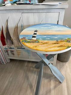 a table with a lighthouse painted on it