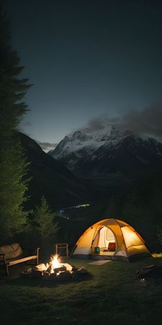 a tent set up in the middle of a field at night with a campfire