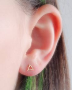 "Modern simplicity. These 14 karat gold, open triangle studs are casual and easy. Great for workdays or weekends. * T H E * D E T A I L S * * All components are solid 14 karat gold * Triangle measures 5mm * Post measures 9mm long * Thoughtfully packaged & ready for gift giving! * Handmade, just for you, in our sunny California Studio * Our 365 Guarantee: Our jewelry is guaranteed for 1 year after purchase date against defects. * Your jewelry is always beautifully and carefully wrapped in a s Minimalist Triangle Jewelry, Minimalist Triangle Jewelry For Pierced Ears, Triangle Yellow Gold Earrings For Gift, Hypoallergenic Triangle Earrings For Gift, Triangle Pierced Earrings Gift, Triangle Pierced Earrings As Gift, Triangle Earrings As Gift, Triangle Ear Wire Jewelry For Gifts, Tiny Gold Earrings