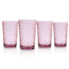 four pink glasses are lined up against a white background