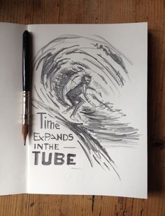 an open book with a drawing of a man riding a surfboard in the tube