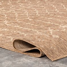 an area rug that has been placed on the floor with no carpeting or covering it