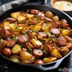 a skillet filled with cooked sausage and potatoes