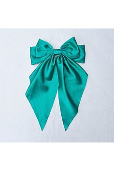 Green Satin Hair Bow for Chic Vintage GlamourBow Hair Clips are deliciously girly - wear with a cheeky smile. Satin is beautifully elegant and chic - and so the combination of the two in this design makes for a statement piece that is both fun to wear, and the perfect finishing touch of vintage style. Green Satin Bow for Movie Star GlamourThis bow hair clip is inspired by red carpet style - vintage hair clips such as the classic black bow, are perfect for red carpet looks, as shown by Julianne Moore, Sydney Sweeney and Tessa Thompson.It is oversized and makes an amazing glamorous statement.We think they work particularly well worn with red lipstick and a glass of celebratory bubbles!Down Hairstyle DazzleAs you can see from our images, we have styled this clip with a loose hair style. If yo Hair Accessories Green, Cheeky Smile, Satin Hair Bow, Long Bow, Vintage Hair Clips, Loose Hair, Tessa Thompson, Sydney Sweeney, Julianne Moore