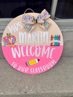 a welcome sign is on the sidewalk for kids to use it as a classroom door hanger