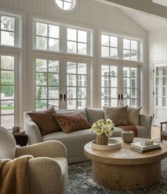 a living room filled with furniture and lots of windows