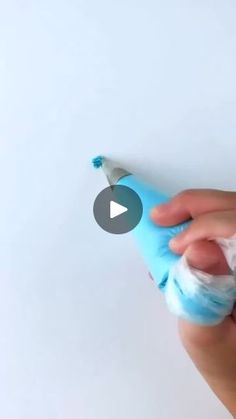 a person holding a blue and white toothbrush in their left hand, with the video below it