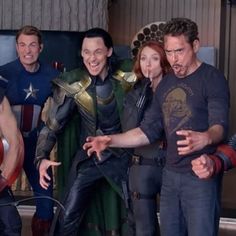 the avengers team is posing for a photo in front of a group of other people